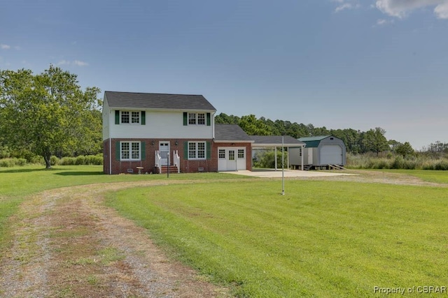 colonial house with a front yard, an outbuilding, dirt driveway, crawl space, and brick siding