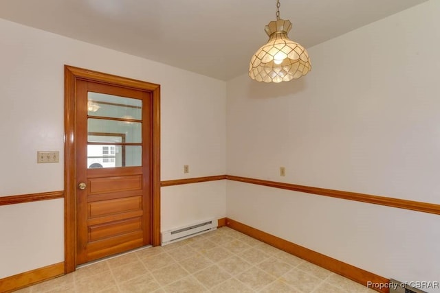 interior space featuring a baseboard heating unit, baseboards, and light floors