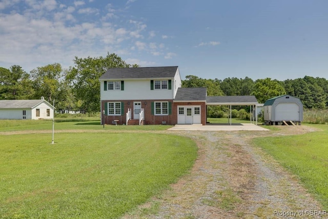 colonial house featuring a front lawn, dirt driveway, an outdoor structure, crawl space, and brick siding