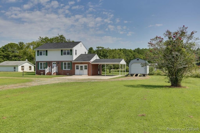 colonial home featuring brick siding, an outbuilding, dirt driveway, and a front yard