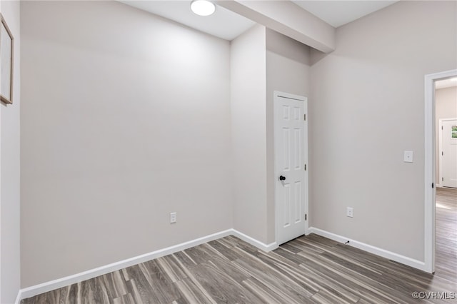 unfurnished room with wood finished floors and baseboards