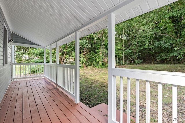 wooden deck featuring a yard