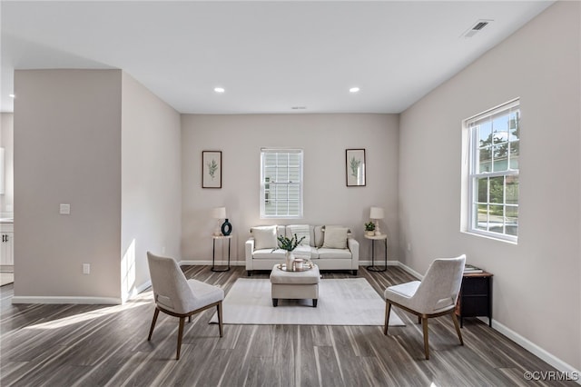 living area with recessed lighting, visible vents, baseboards, and dark wood-style floors