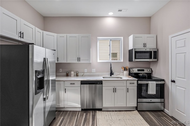 kitchen with visible vents, appliances with stainless steel finishes, light countertops, and a sink