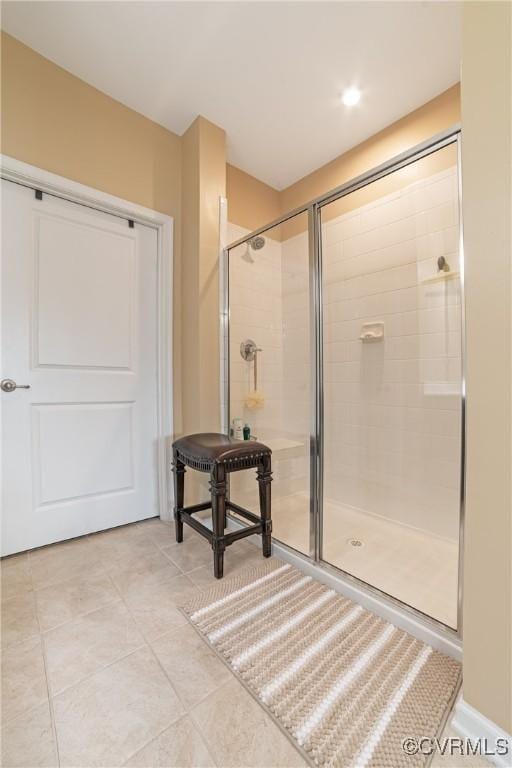 bathroom with tile patterned floors and a tile shower