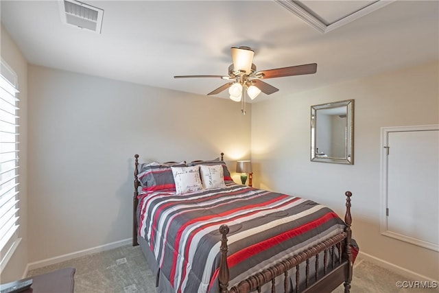 carpeted bedroom featuring visible vents, baseboards, and a ceiling fan