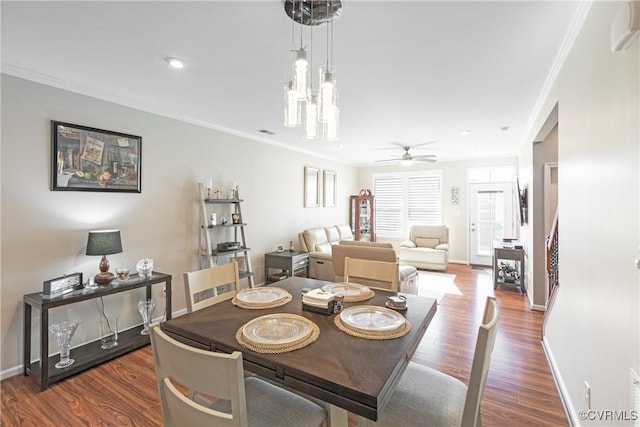 dining area with a ceiling fan, wood finished floors, baseboards, and ornamental molding