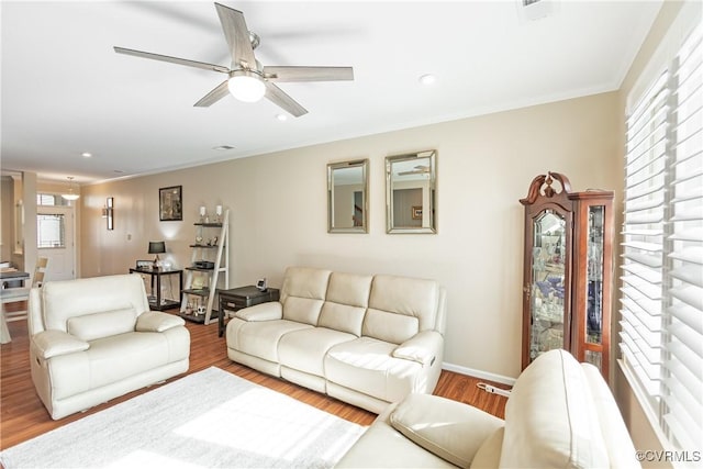 living room featuring crown molding, baseboards, ceiling fan, recessed lighting, and wood finished floors