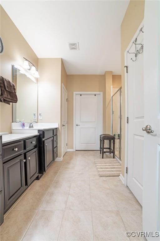 bathroom with vanity, baseboards, visible vents, and a stall shower