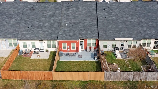 rear view of property featuring a patio area, a residential view, fence private yard, and a yard