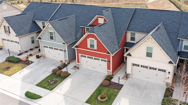 view of front of home with a garage, board and batten siding, driveway, and a shingled roof