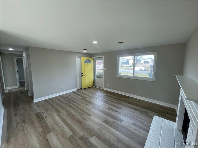 unfurnished living room featuring visible vents, recessed lighting, baseboards, and wood finished floors