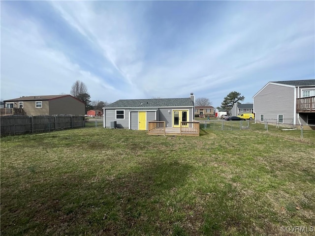 back of house featuring a deck, a yard, and a fenced backyard