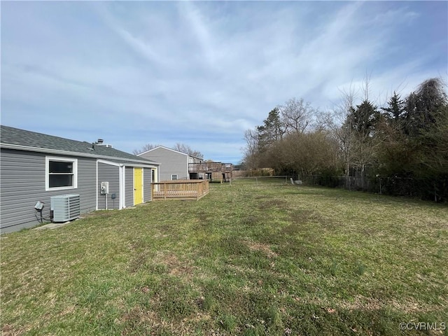 view of yard with central AC unit and fence