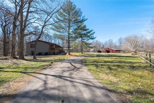 view of road featuring a barn and driveway