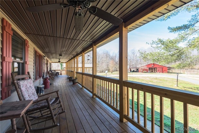 deck with a porch, a lawn, and ceiling fan