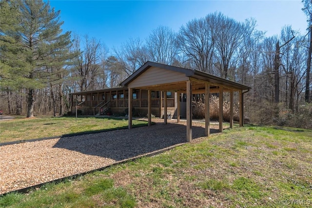 exterior space with a carport, a front lawn, a porch, and driveway