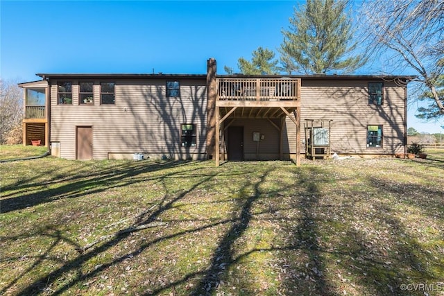 rear view of property with a yard and a deck