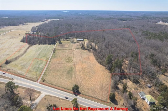 aerial view featuring a view of trees and a rural view