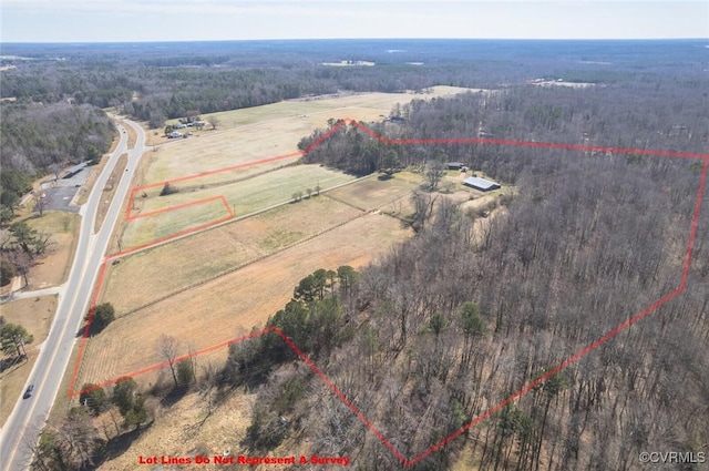 birds eye view of property featuring a forest view and a rural view