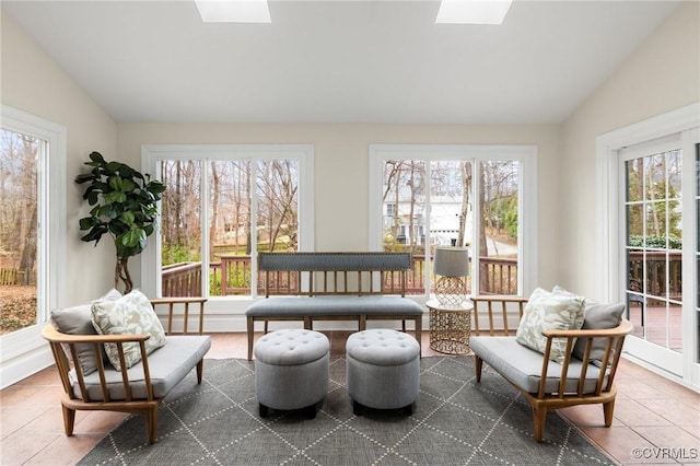 sunroom featuring lofted ceiling with skylight