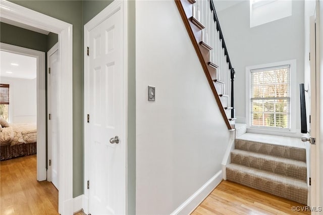 stairs with baseboards and wood finished floors