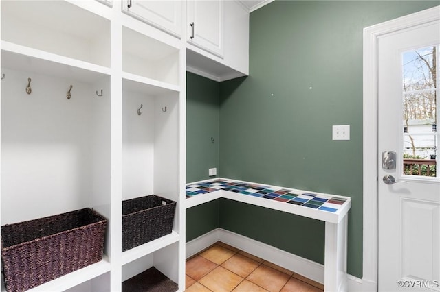 mudroom with light tile patterned floors and baseboards