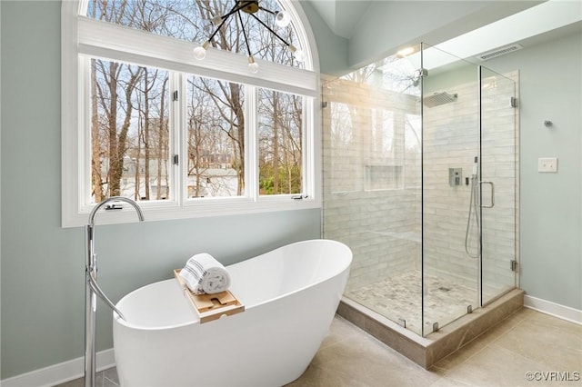 full bathroom featuring visible vents, a shower stall, tile patterned flooring, baseboards, and a soaking tub