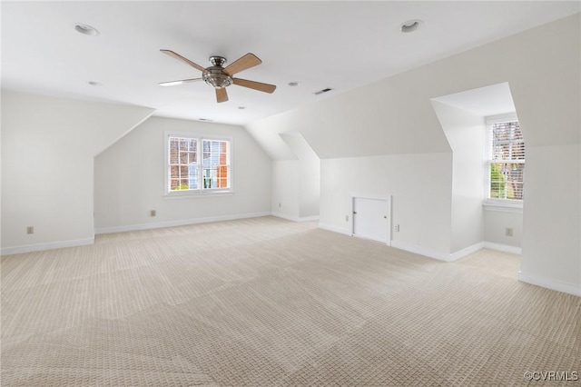 bonus room featuring baseboards, light colored carpet, ceiling fan, and vaulted ceiling