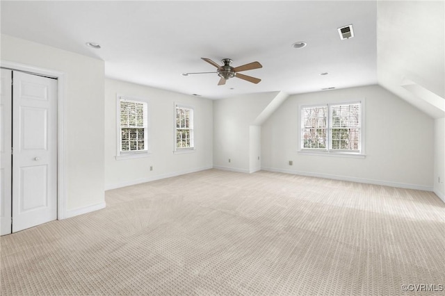 bonus room with light colored carpet, lofted ceiling, baseboards, and ceiling fan