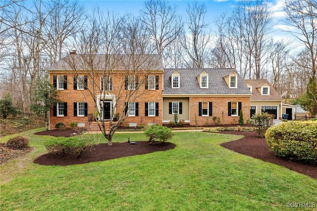 view of front facade with a front yard, brick siding, roof with shingles, and crawl space