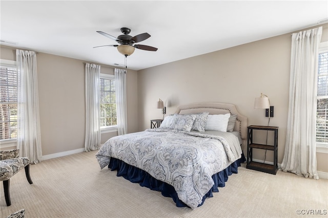 carpeted bedroom featuring visible vents, ceiling fan, and baseboards