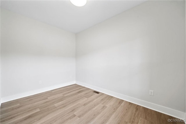 unfurnished room with visible vents, baseboards, and light wood finished floors