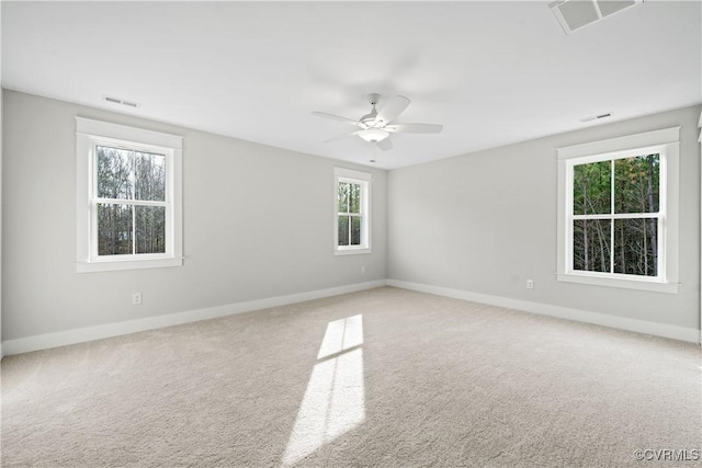 carpeted spare room with visible vents and baseboards