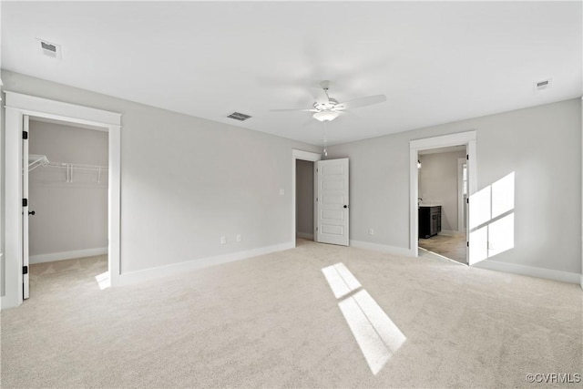 unfurnished bedroom featuring visible vents and light carpet