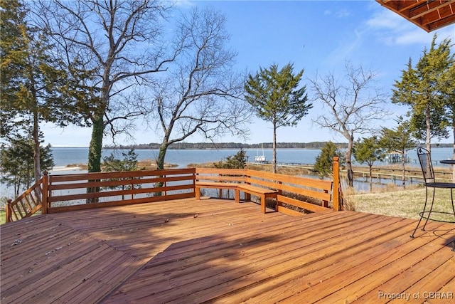 wooden terrace featuring a water view