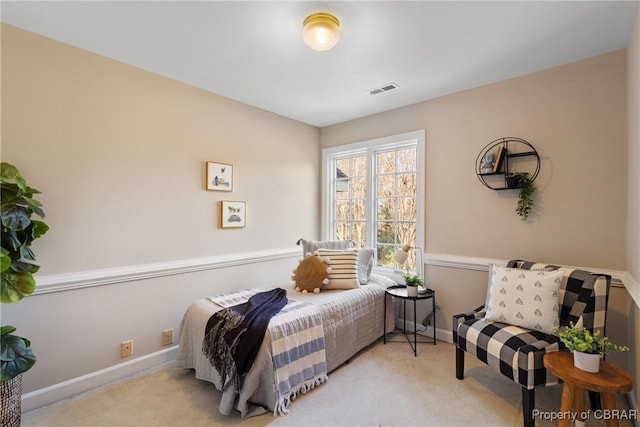 bedroom featuring visible vents, baseboards, and carpet