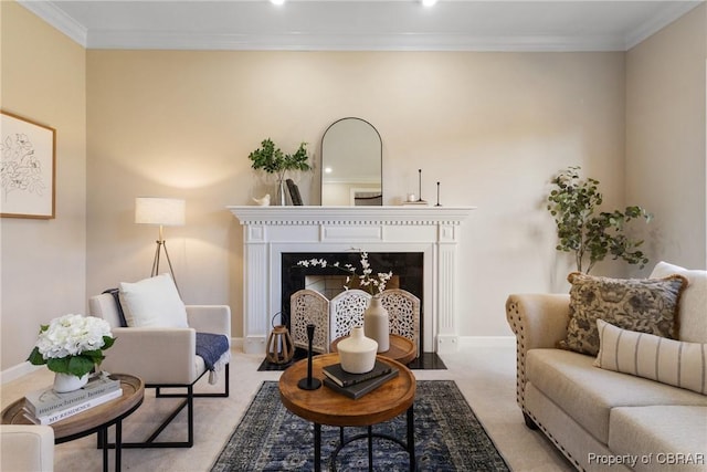 sitting room with crown molding, carpet flooring, baseboards, and a fireplace with flush hearth