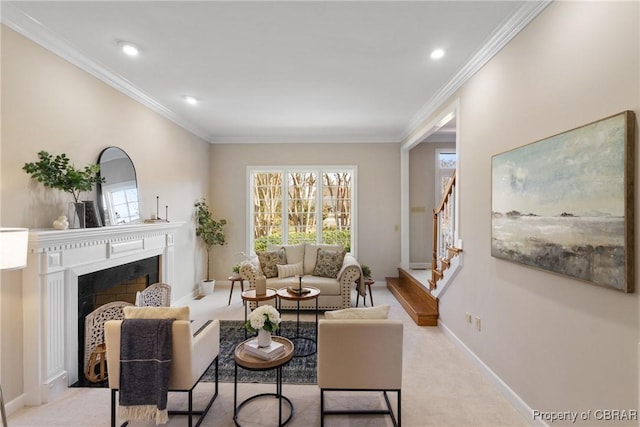 carpeted living area with a wealth of natural light, a fireplace with flush hearth, and crown molding