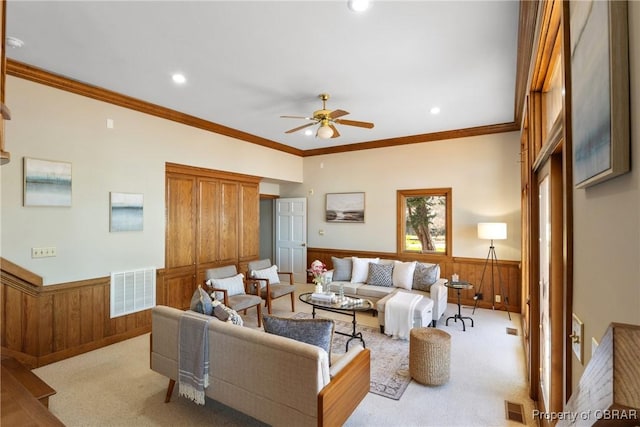 living room featuring visible vents, carpet floors, and wainscoting