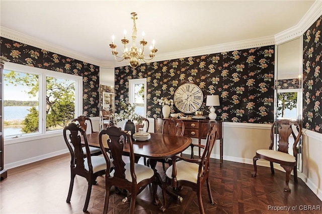 dining room with wallpapered walls, a notable chandelier, baseboards, and a water view