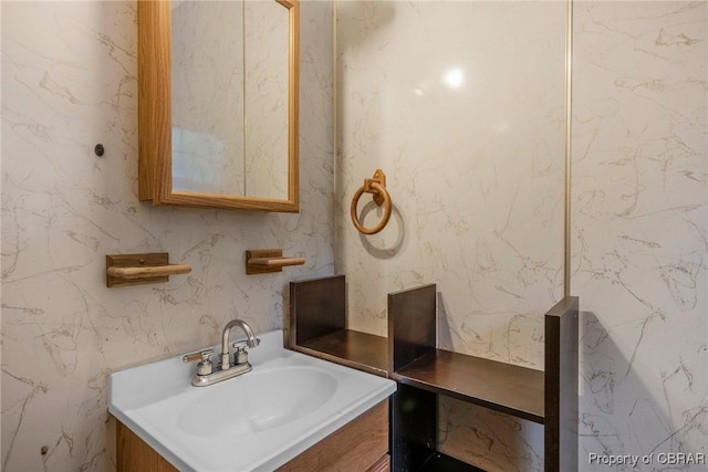 bathroom with vanity and wallpapered walls