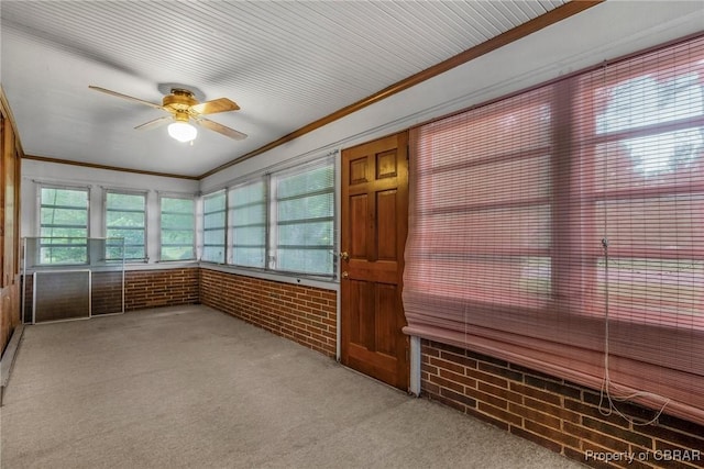 unfurnished sunroom with a ceiling fan