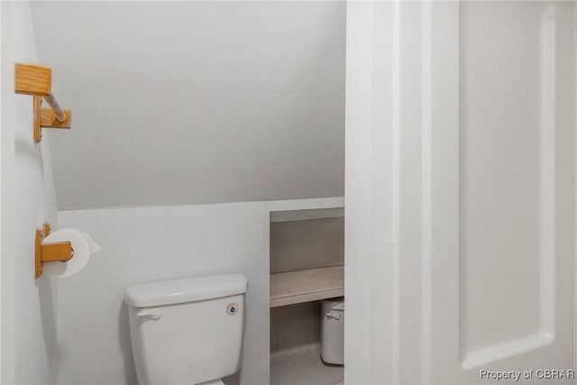 bathroom with toilet and vaulted ceiling