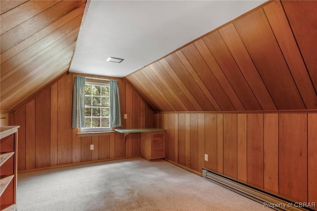 additional living space featuring wooden walls, carpet flooring, lofted ceiling, and a baseboard radiator