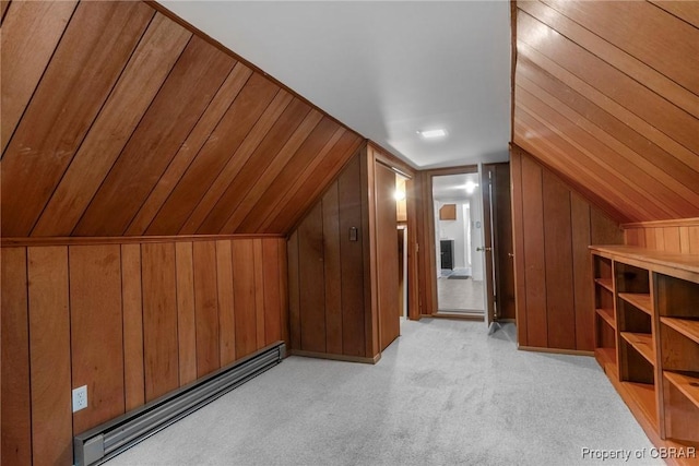 additional living space featuring lofted ceiling, wooden walls, light colored carpet, and a baseboard radiator