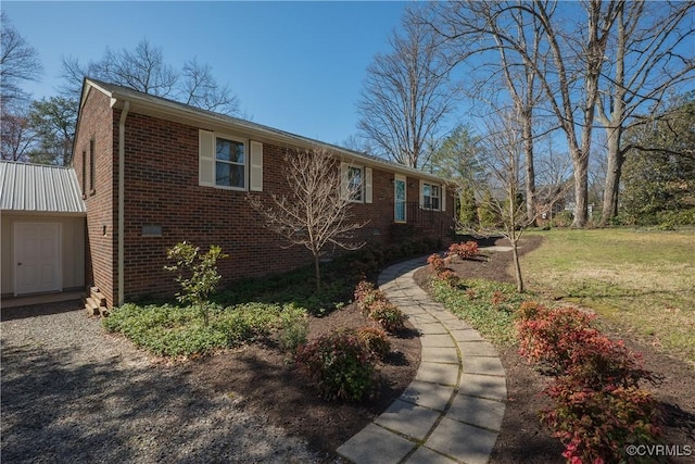 view of front of house with brick siding and a front lawn