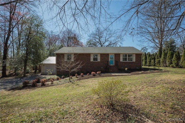 ranch-style home featuring a front lawn, brick siding, and crawl space