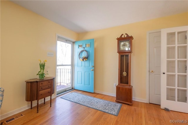 entrance foyer featuring wood finished floors, visible vents, and baseboards