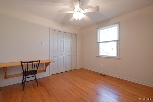 bedroom featuring visible vents, ceiling fan, baseboards, light wood-type flooring, and a closet